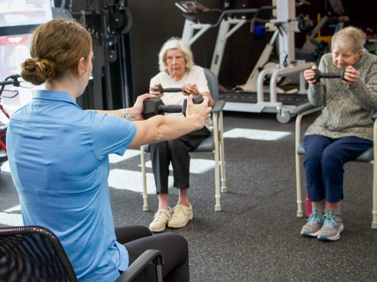 An exercise physiologist with clients doing a guided strength session at SAVVY